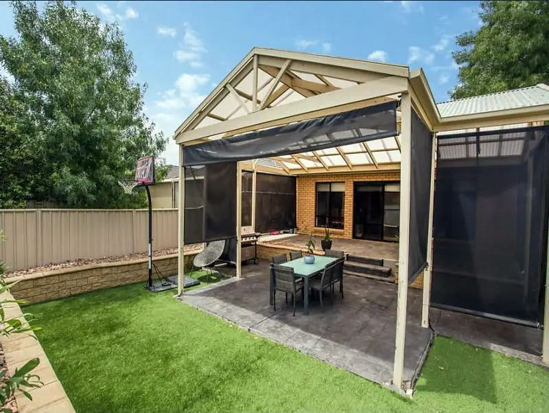 The covered pergola and lawn at the back of the Condamine Street home