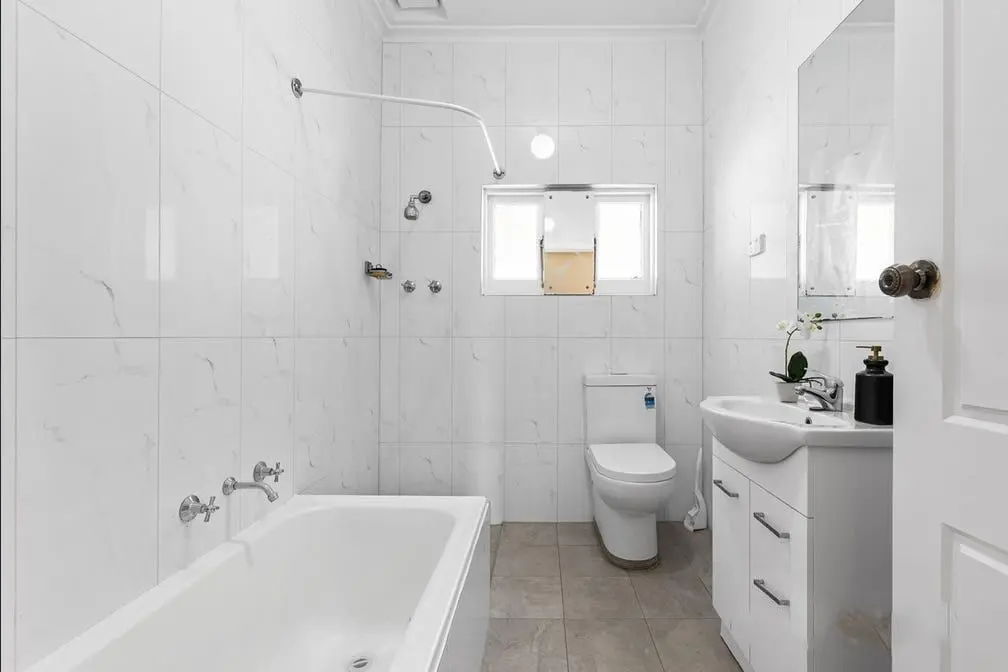 The bathroom at the Colton Avenue home, with a bath, shower and vanity