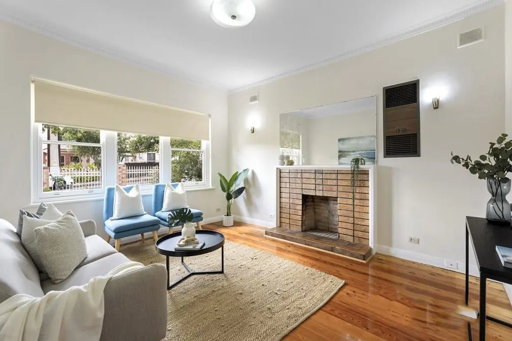 The lounge at the Colton Avenue home, with timber floors and a brick fireplace