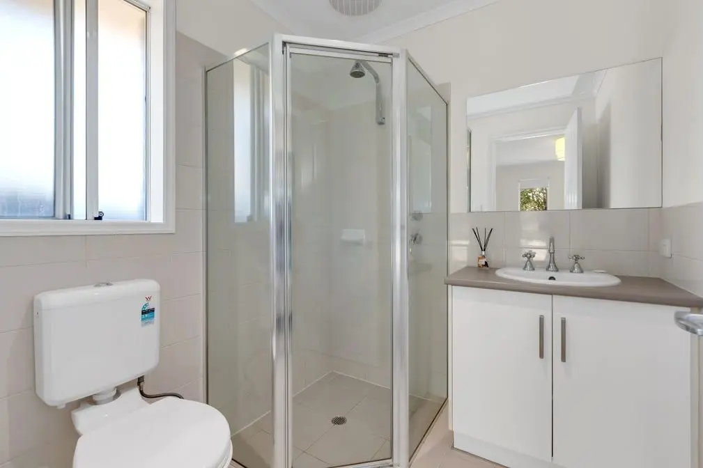 The bathroom at the Peerless Road home, with a corner shower and vanity