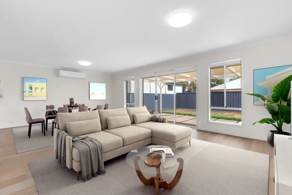 The open-plan living and dining area at the Peerless Road home, with sliding doors to the yard