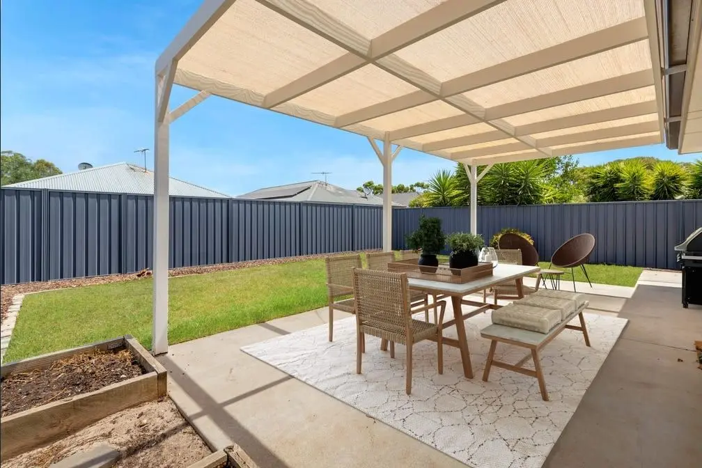 The covered pergola and lawn at the back of the Peerless Road home