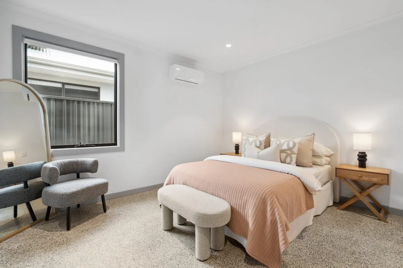 A bedroom at the Wyndham Road home, with a double bed and a wall-mounted air conditioner